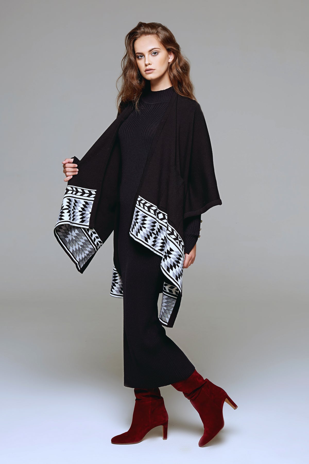 Knitted merino wool cape with geometric border
