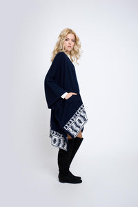 Knitted merino wool cape with geometric border