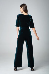 Velvet jumpsuit with bell sleeves and sash in emerald green