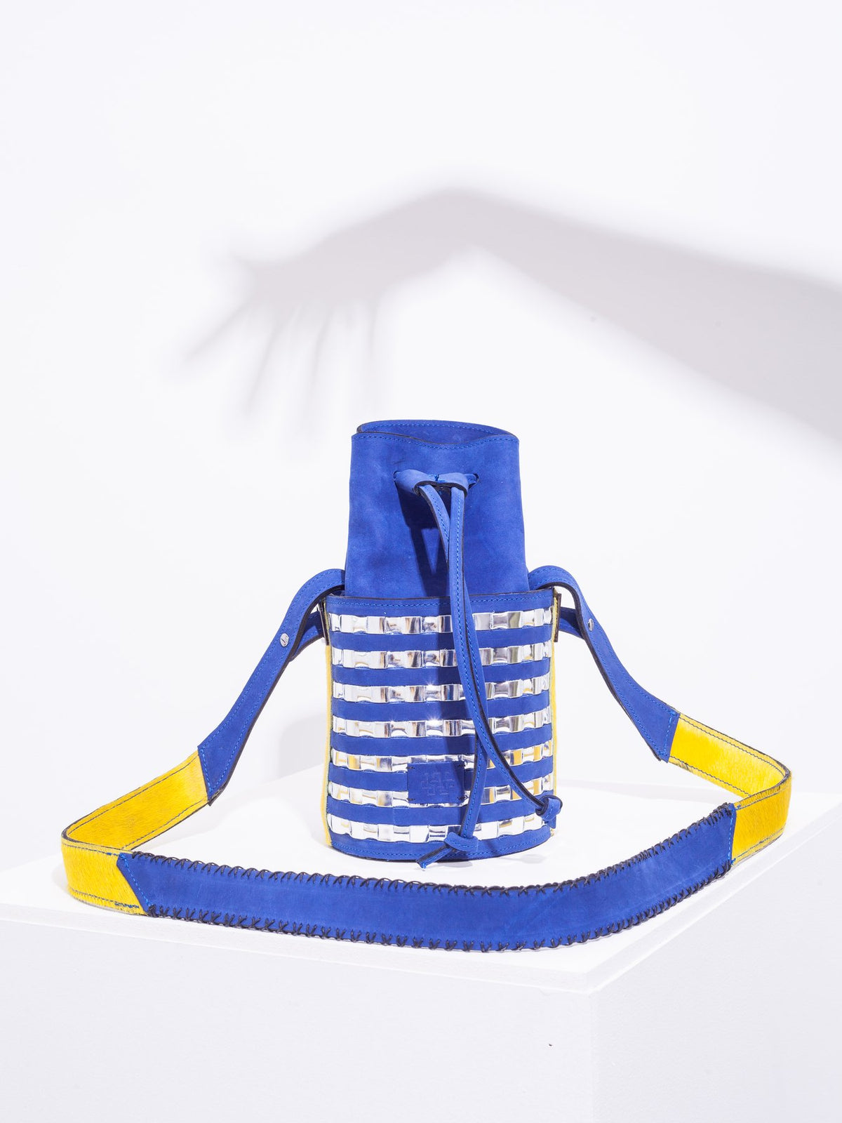 Mini circular bucket bag in royal blue with striped silver mirror effect