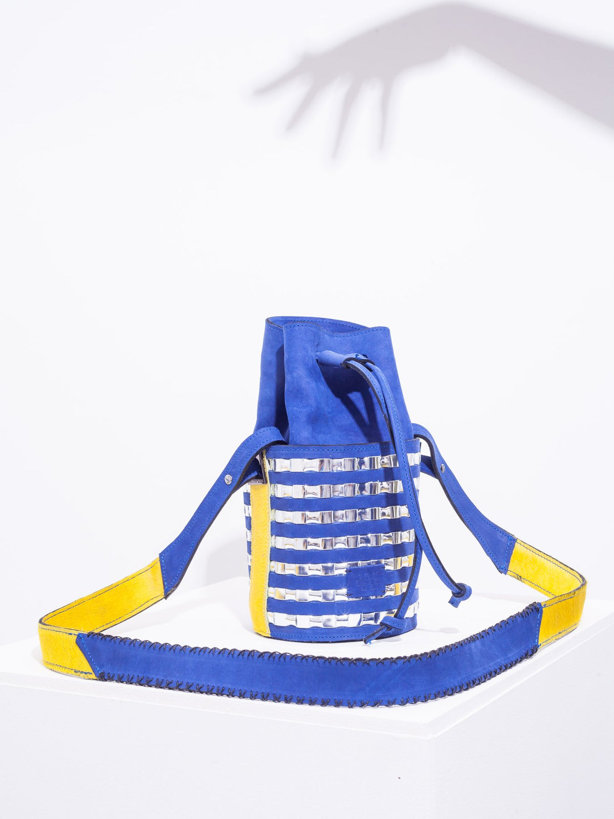 Mini circular bucket bag in royal blue with striped silver mirror effect